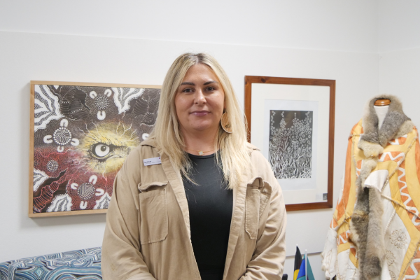 picture of Sarah in front of an Aboriginal painting
